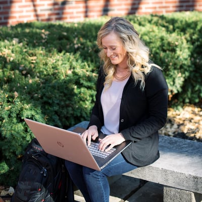 Woman taking an online course outside Woman taking an online course outside