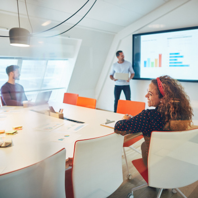 Woman in meeting room with colleagues Woman in meeting room with colleagues